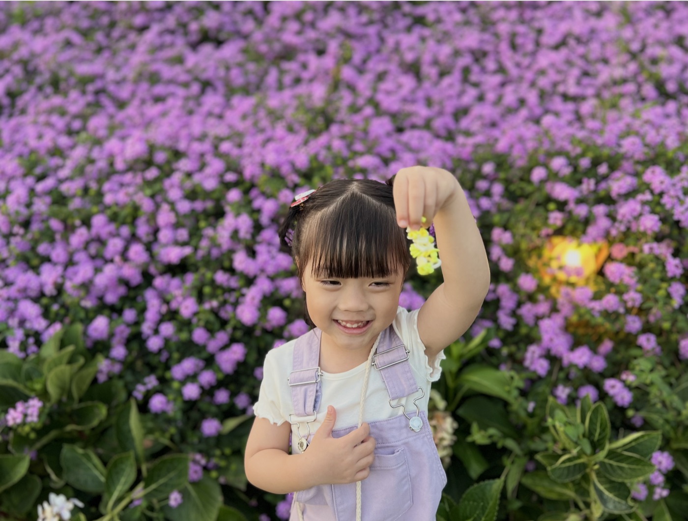Demi’s daughter smiling in a field of purple flowers